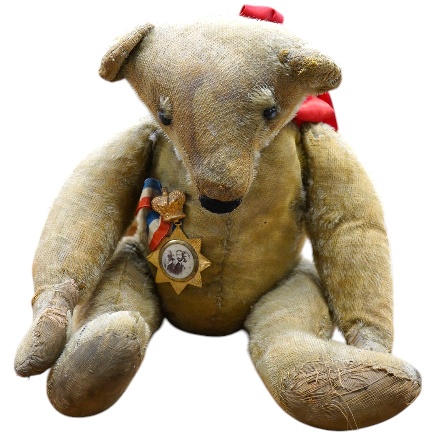 An early German bear wearing medal commemorating Queen Victoria's Jubilee, hair loss and general wear and staining to mohair, c.1912, 48cm high